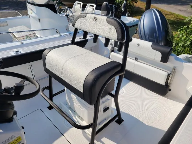 Slide: The Image of 2025 Edgewater 208 WATCHMAN boat interior with cushioned seating and steering wheel. - 14