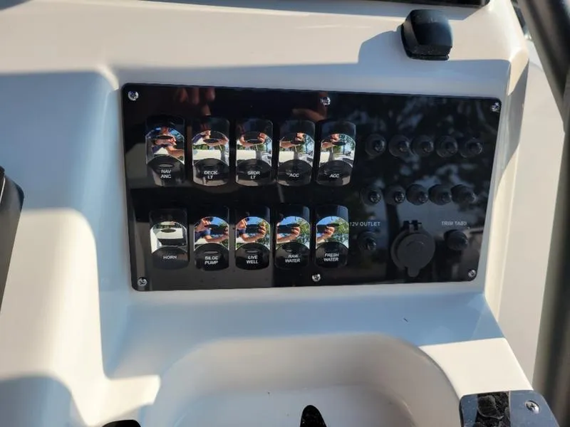 Slide: The Image of Control panel of 2025 Edgewater 208 WATCHMAN boat with labeled switches and outlets. - 16