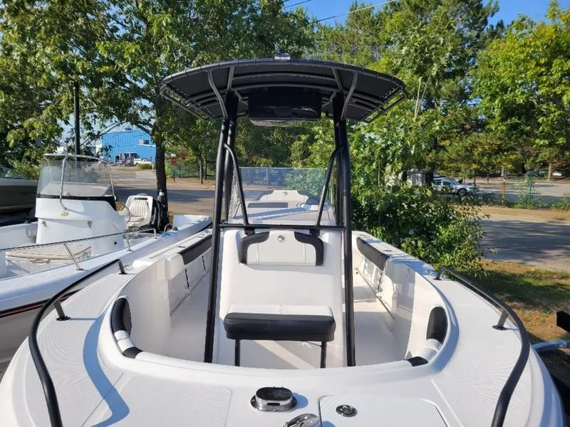 Slide: The Image of 2025 Edgewater 208 WATCHMAN boat, sleek design, outdoor setting, surrounded by trees. - 17