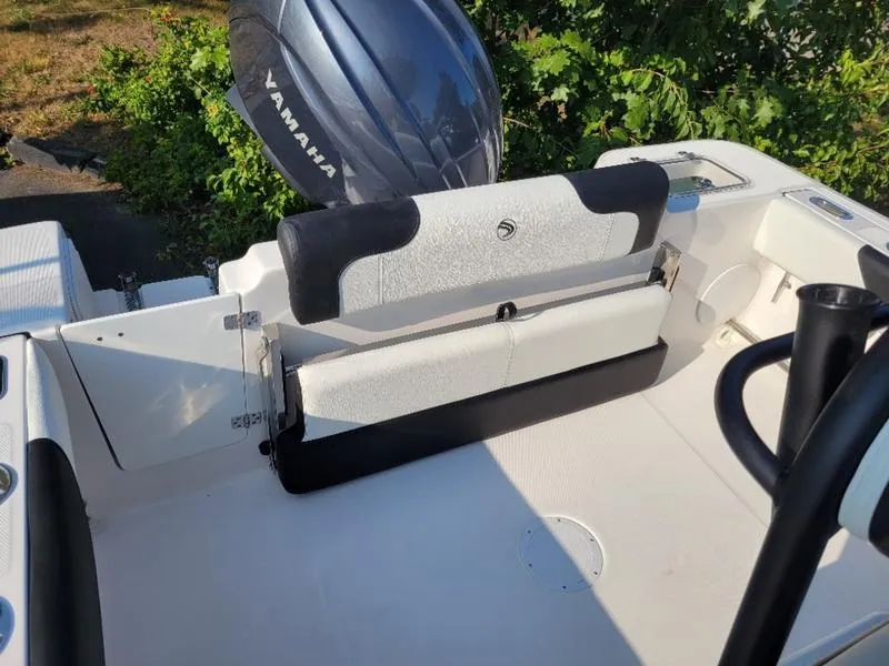 Slide: The Image of 2025 Edgewater 208 WATCHMAN boat interior with Yamaha engine, featuring seating and storage. - 4