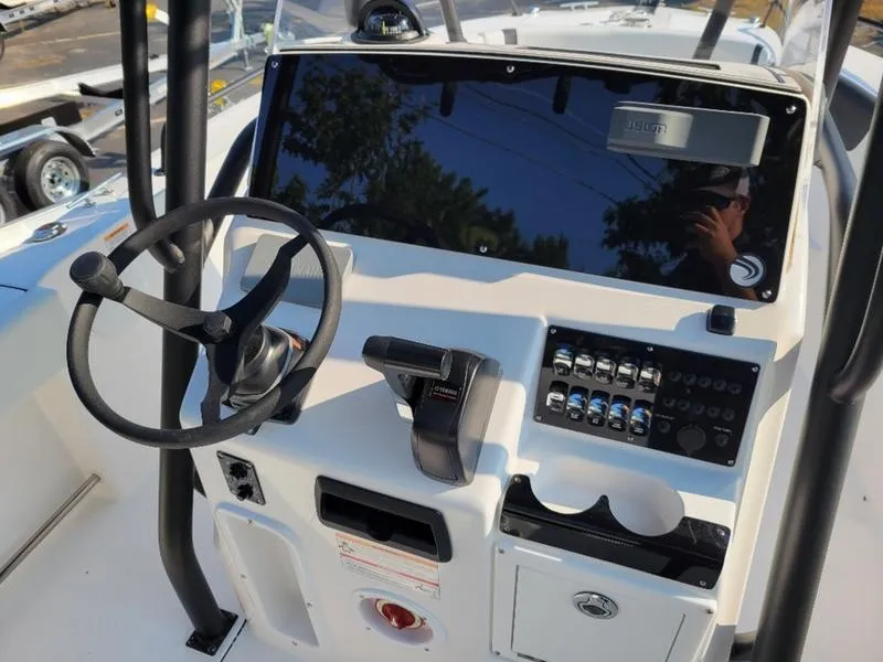 Slide: The Image of Edgewater 208 WATCHMAN 2025 boat dashboard with steering wheel and control panel. - 9
