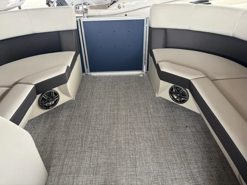 Slide: The Image of Interior of 2025 Harris Cruiser 210 SL boat with stylish seating and speakers. - 10