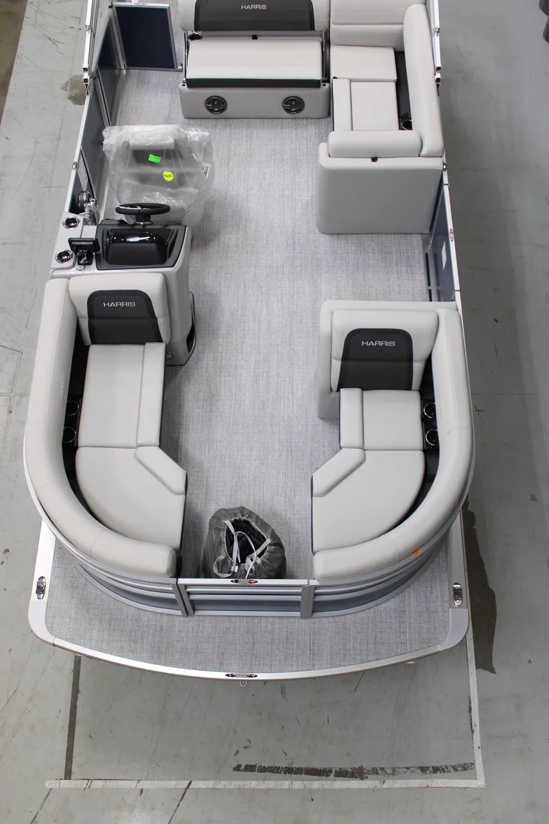 Slide: The Image of 2025 Harris Cruiser 210 SL pontoon boat interior with plush seating and modern design. - 2