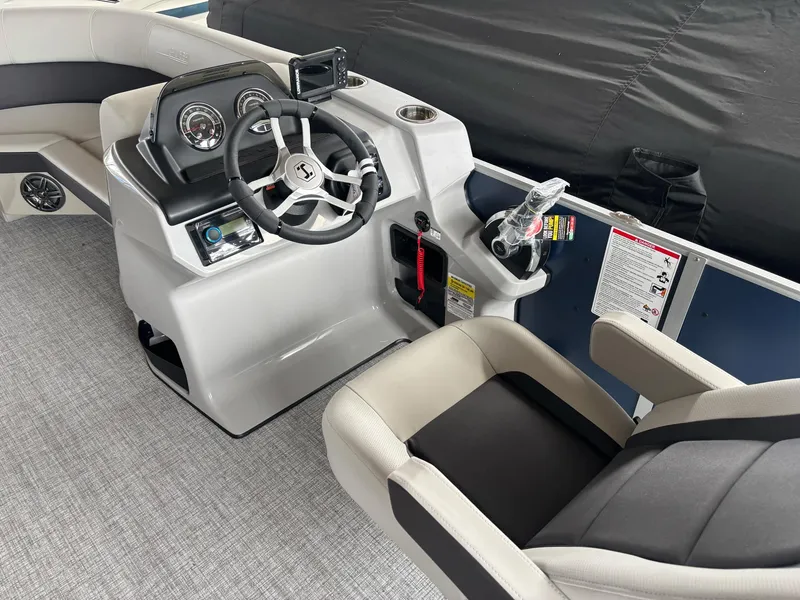 Slide: The Image of 2025 Harris Cruiser 210 SL boat interior with modern steering console and comfortable seating. - 3