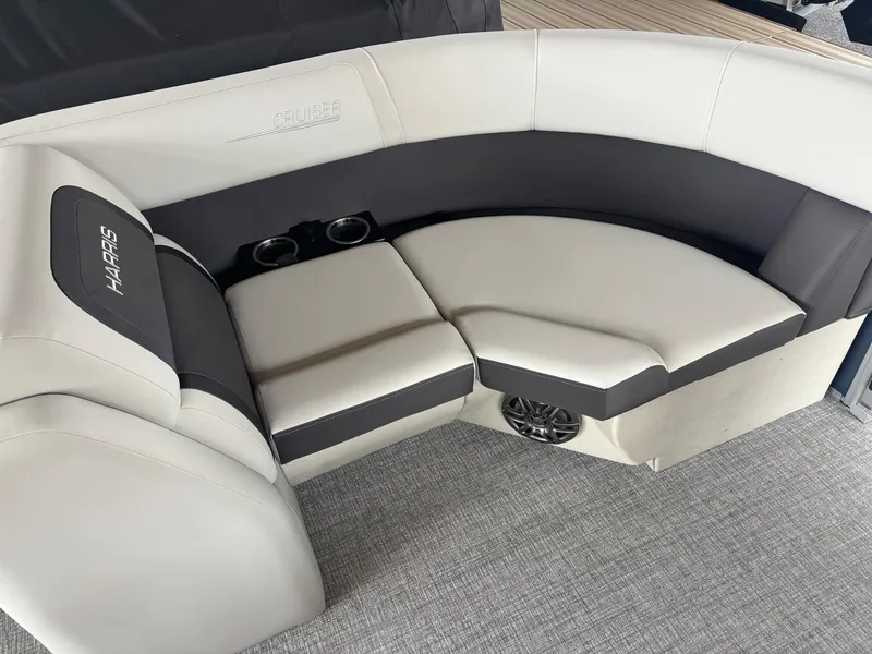 Slide: The Image of 2025 Harris Cruiser 210 SL boat seating with cup holders and speaker, featuring modern design. - 6