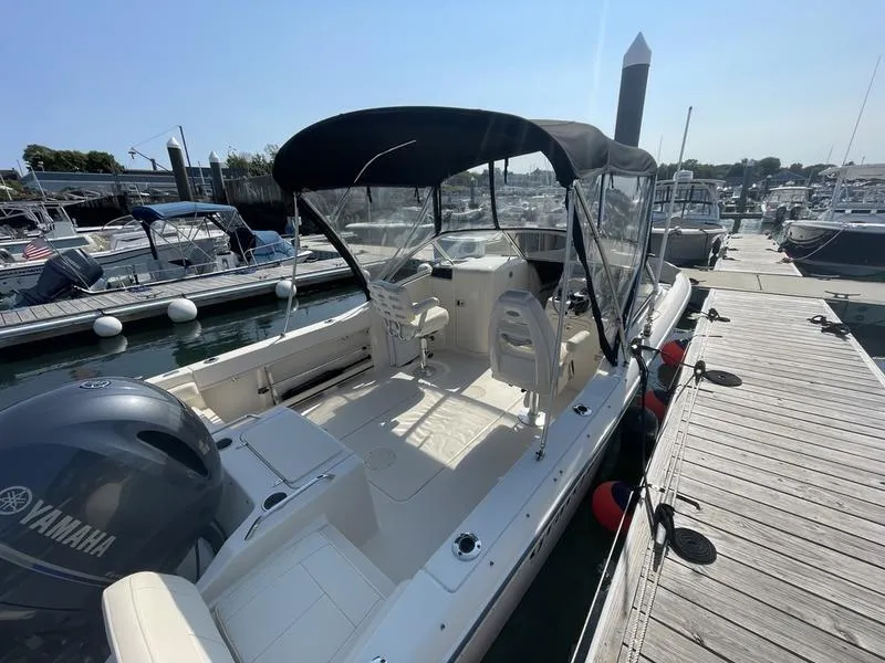 Slide: The Image of 2020 Grady-White 215 Freedom boat docked with Yamaha engine, clear canopy. - 2
