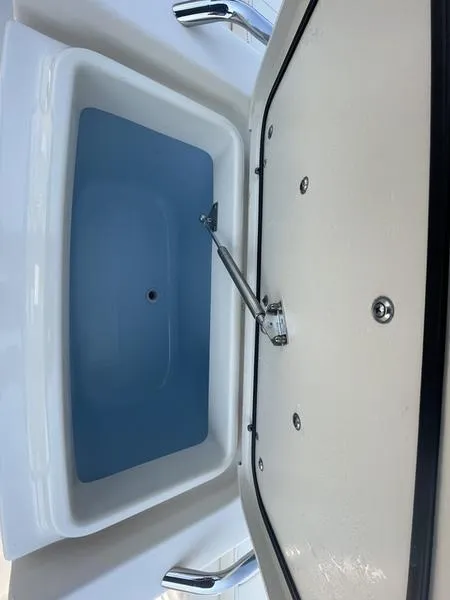 Slide: The Image of 2020 Grady-White 215 Freedom boat storage compartment with open lid. - 4