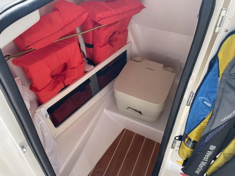 Slide: The Image of 2020 Grady-White 215 Freedom boat interior with life jackets and portable toilet. - 6