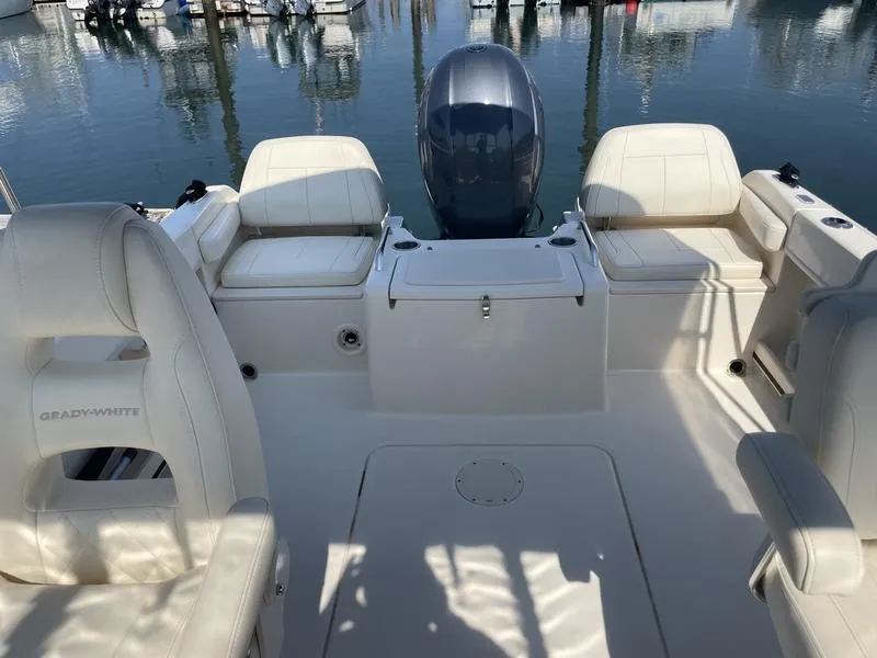 Slide: The Image of 2020 Grady-White 215 Freedom boat interior with seating and motor, docked at marina. - 8