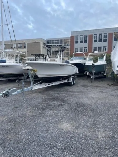 Slide: The Image of 2021 Key West 239FS boat on trailer in a parking lot. - 2