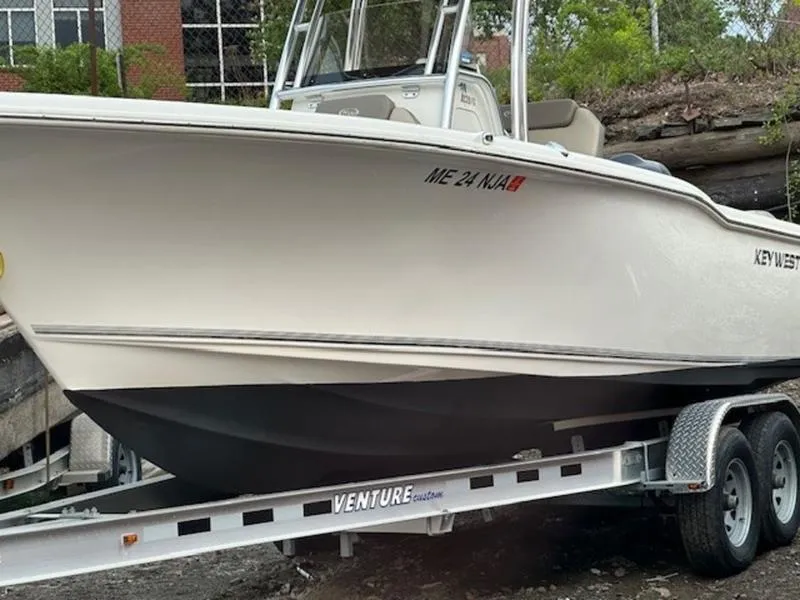 Slide: The Image of 2021 Key West 239FS boat on Venture trailer, parked outdoors. - 3
