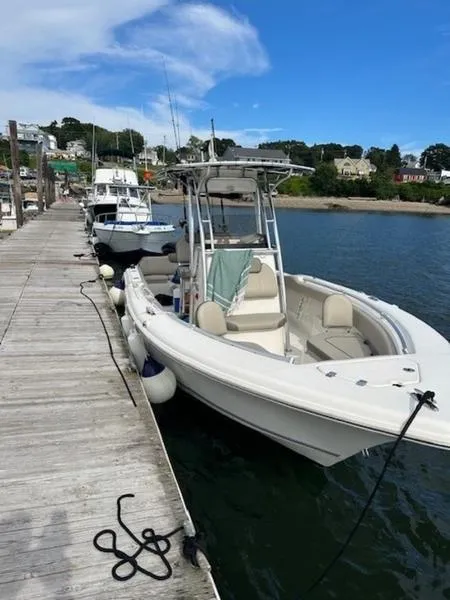 Slide: The Image of 2021 Key West 239FS boat docked at marina under clear blue sky. - 4