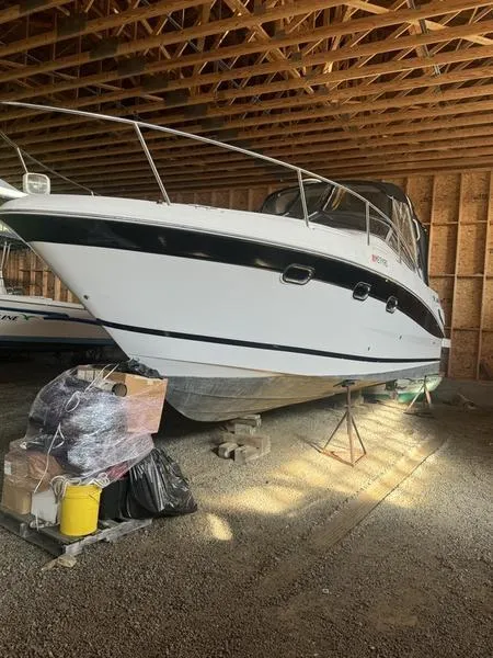The Image of 2005 Four Winns 298 Vista boat stored in a wooden garage. - 0