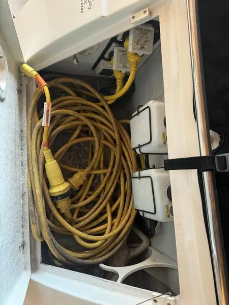 Slide: The Image of Coiled yellow power cable in 2005 Four Winns 298 Vista boat compartment. - 13