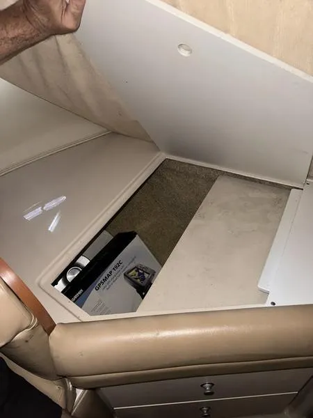 Slide: The Image of 2005 Four Winns 298 Vista storage compartment with battery box. - 16