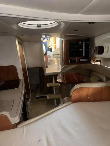 Slide: The Image of Interior of 2005 Four Winns 298 Vista boat with seating and wood accents. - 17