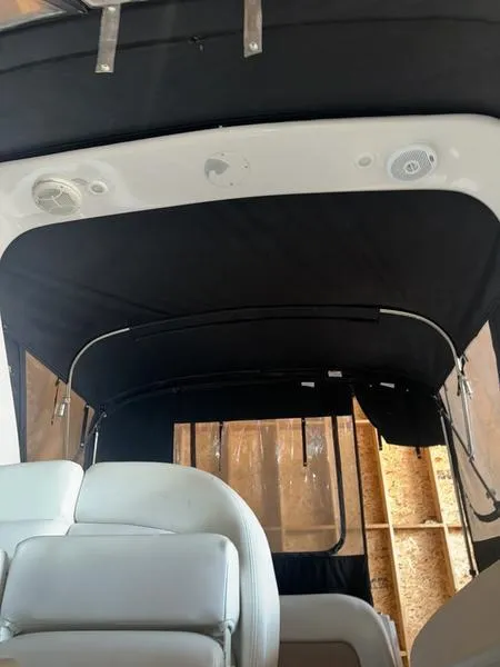 Slide: The Image of 2005 Four Winns 298 Vista boat interior with black canopy and white seating. - 19