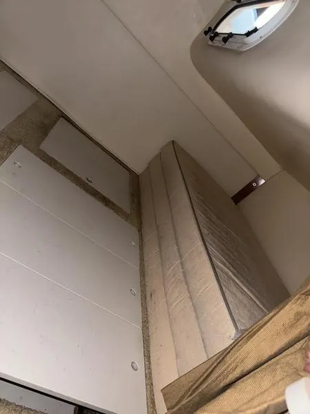 Slide: The Image of Interior cabin of 2005 Four Winns 298 Vista boat with mattress and porthole. - 2