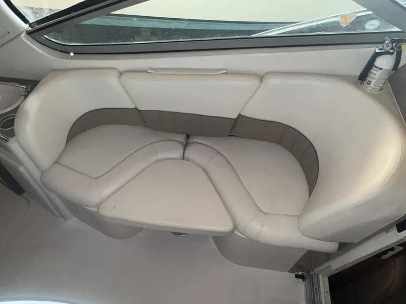 Slide: The Image of 2005 Four Winns 298 Vista boat interior with beige seating and a fire extinguisher. - 24