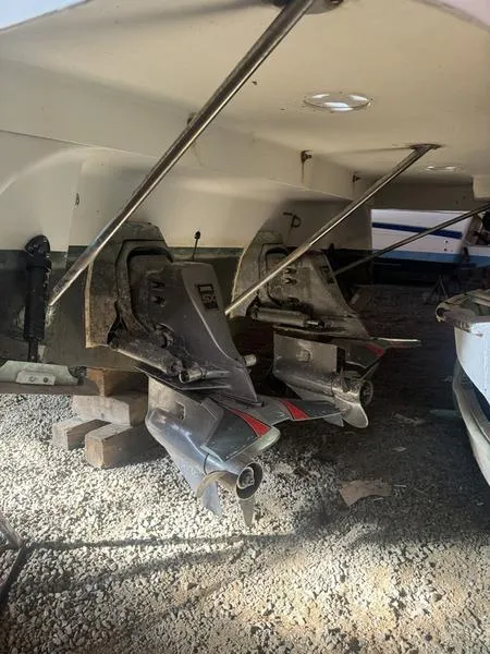 Slide: The Image of 2005 Four Winns 298 Vista boat outdrives on gravel surface. - 25