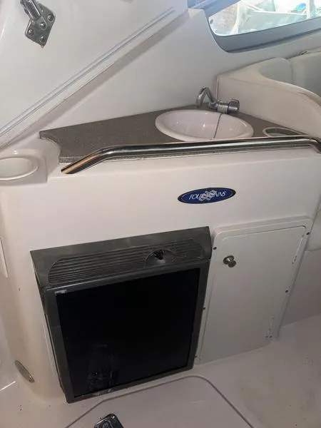 Slide: The Image of 2005 Four Winns 298 Vista boat interior with sink and storage cabinet. - 29