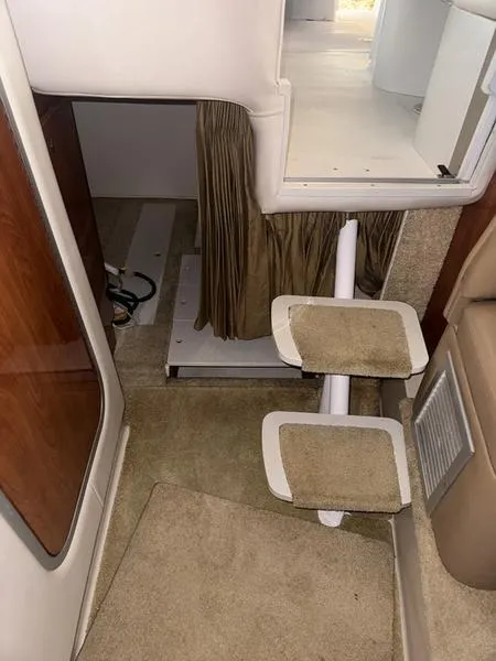 Slide: The Image of Interior of 2005 Four Winns 298 Vista boat with carpeted steps and wooden accents. - 30