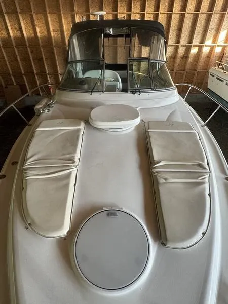 Slide: The Image of 2005 Four Winns 298 Vista boat with cushioned deck, stored indoors. - 34