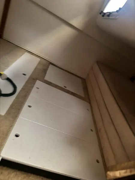 Slide: The Image of Interior cabin of 2005 Four Winns 298 Vista boat, featuring white panels and seating. - 39