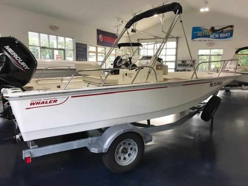 Slide: The Image of 2023 Boston Whaler 170 Montauk boat on trailer in showroom. - 11