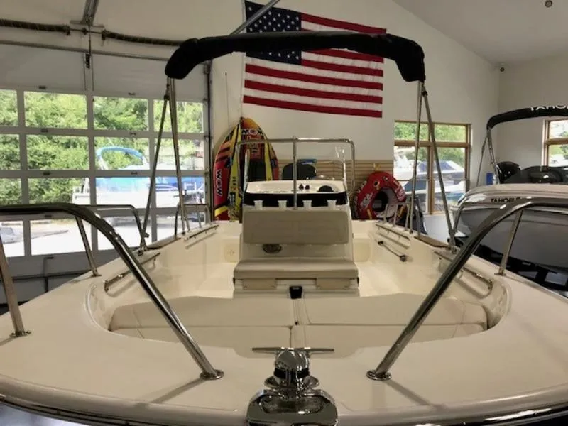 Slide: The Image of 2023 Boston Whaler 170 Montauk boat in showroom with American flag backdrop. - 7