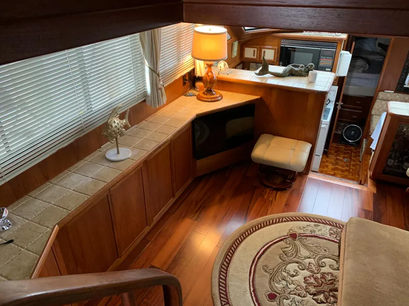 Slide: The Image of Interior of 1989 Carver Californian 48 yacht with wood flooring and cozy decor. - 19