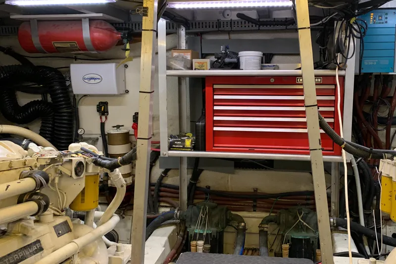 Slide: The Image of Engine room of 1989 Carver Californian 48 with red tool chest and equipment. - 27