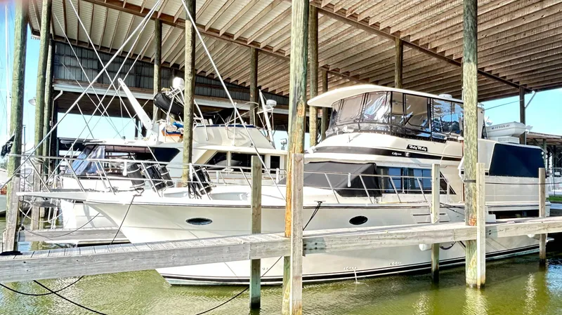 Slide: The Image of 1989 Carver Californian 48 yacht docked in a covered marina. - 3