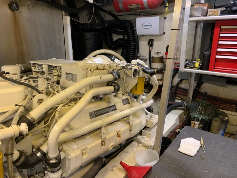 Slide: The Image of Engine room of a 1989 Carver Californian 48 yacht, featuring a well-maintained engine and tools. - 35