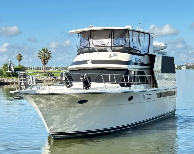 The Image of 1989 Carver Californian 48 yacht on calm water, under a clear blue sky. - 0