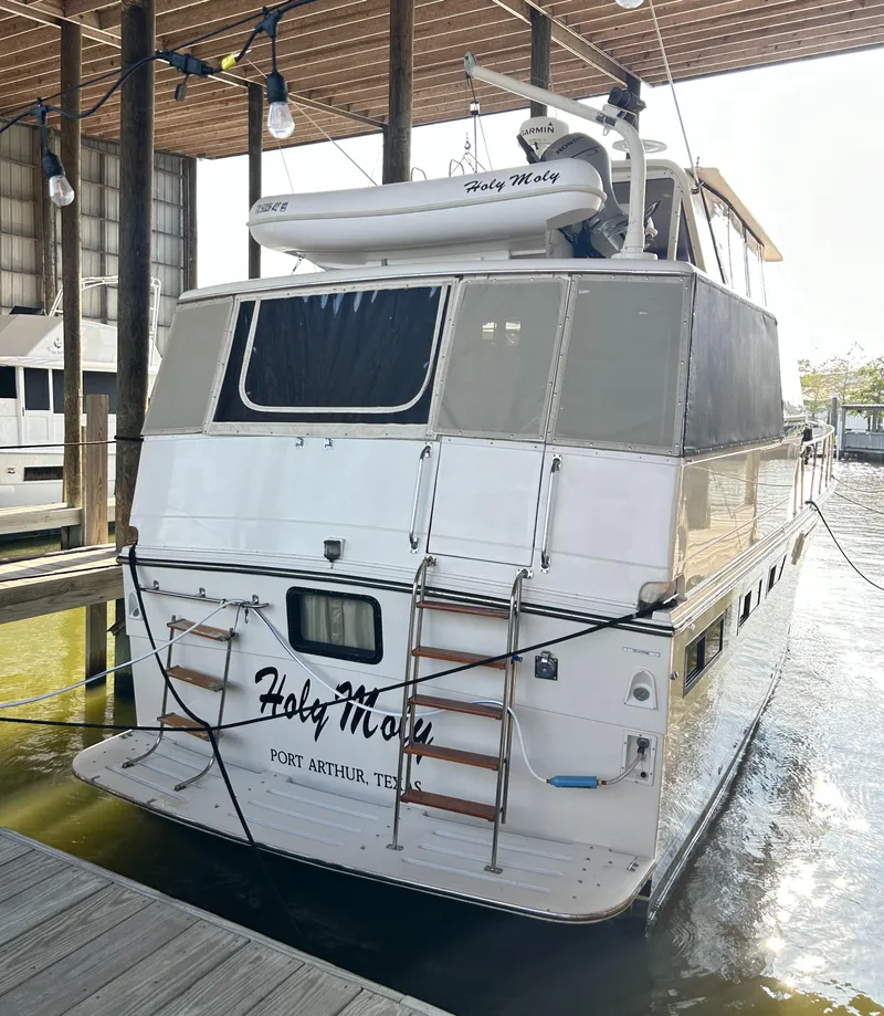 Slide: The Image of 1989 Carver Californian 48 yacht docked, rear view, with "Holy Moly" name, Port Arthur, Texas. - 14
