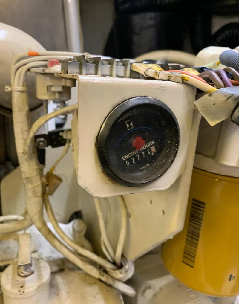 Slide: The Image of Engine hour meter on 1989 Carver Californian 48, showing 2177 hours, with surrounding wiring. - 29