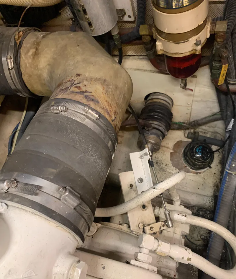 Slide: The Image of Engine room of 1989 Carver Californian 48 yacht with visible hoses and components. - 30