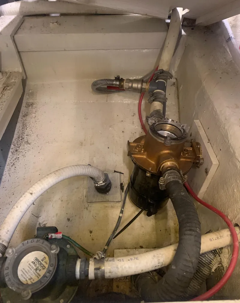 Slide: The Image of Engine compartment of 1989 Carver Californian 48 with visible plumbing and mechanical components. - 31