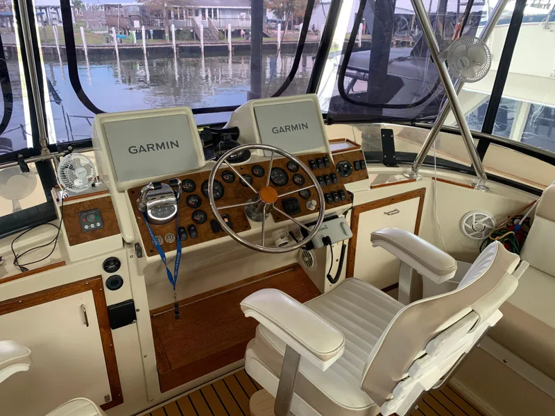 Slide: The Image of Helm of 1989 Carver Californian 48 yacht with Garmin navigation systems and captain's chair. - 32