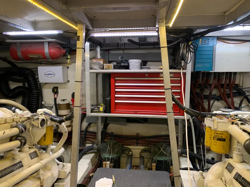Slide: The Image of Engine room of 1989 Carver Californian 48 yacht with tools and equipment. - 34