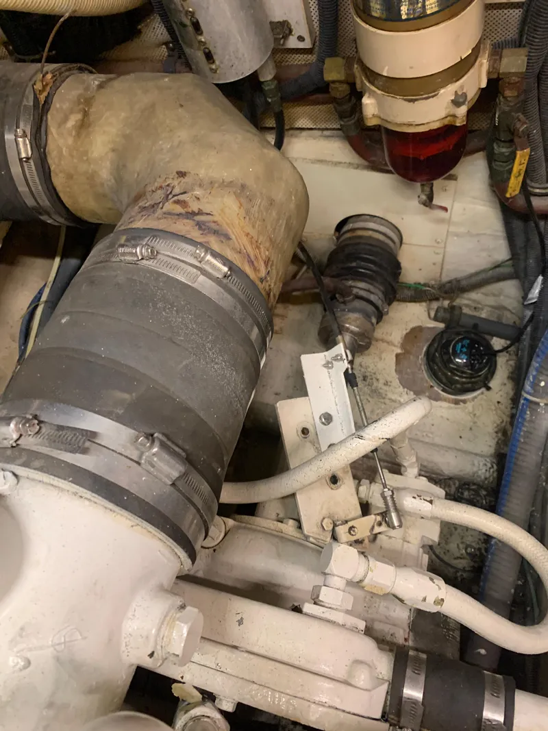 Slide: The Image of Engine room of 1989 Carver Californian 48 yacht with visible hoses and components. - 39