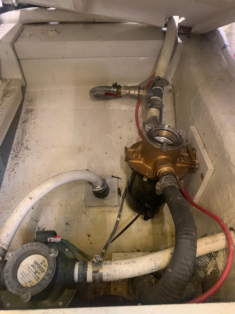 Slide: The Image of Engine compartment of a 1989 Carver Californian 48 with visible hoses and mechanical components. - 40