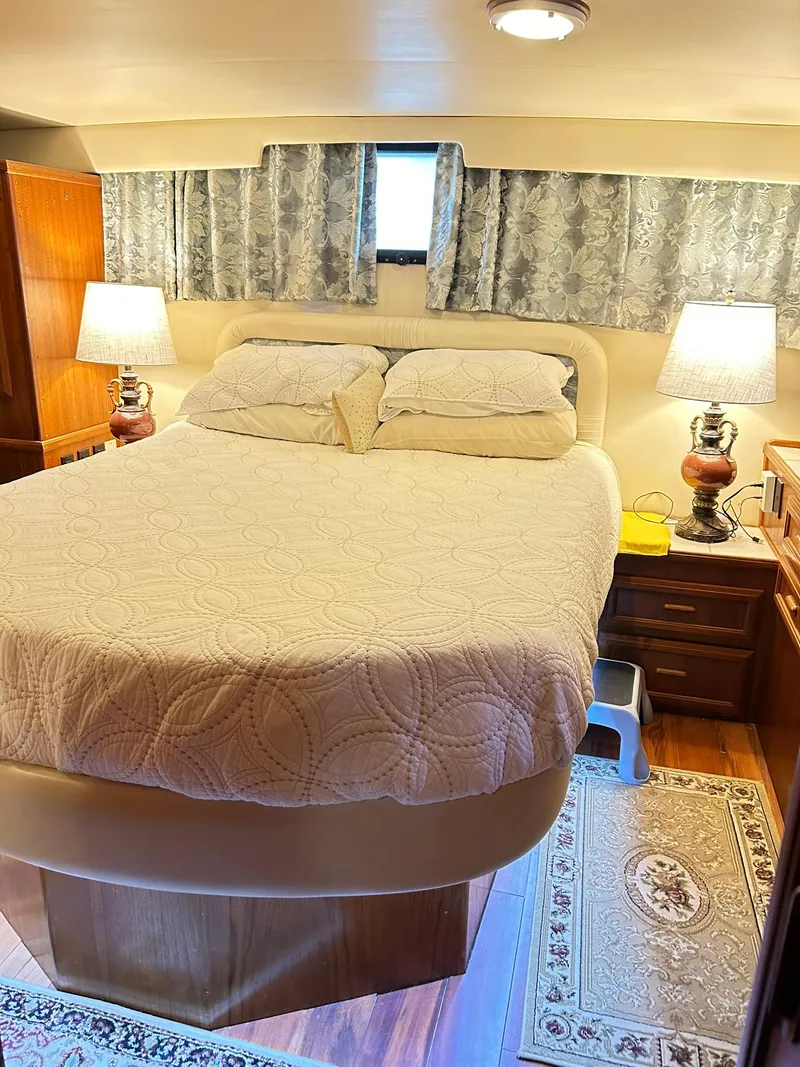 Slide: The Image of Cozy bedroom in 1989 Carver Californian 48 yacht with elegant bedding and warm lighting. - 46