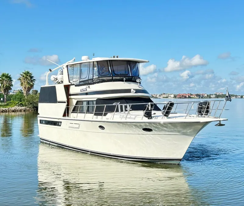 Slide: The Image of 1989 Carver Californian 48 yacht cruising on a sunny day with clear skies. - 6