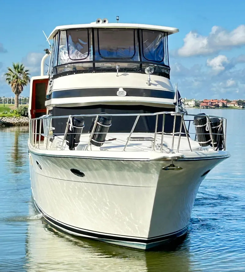 Slide: The Image of 1989 Carver Californian 48 yacht on calm water, clear sky background. - 7