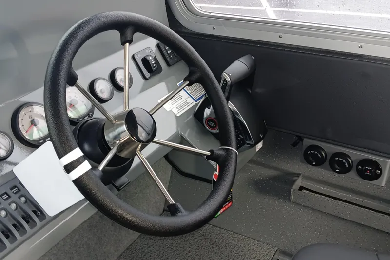 Slide: The Image of Steering wheel and dashboard of 2025 Spartan 2800 Olympia boat. - 11