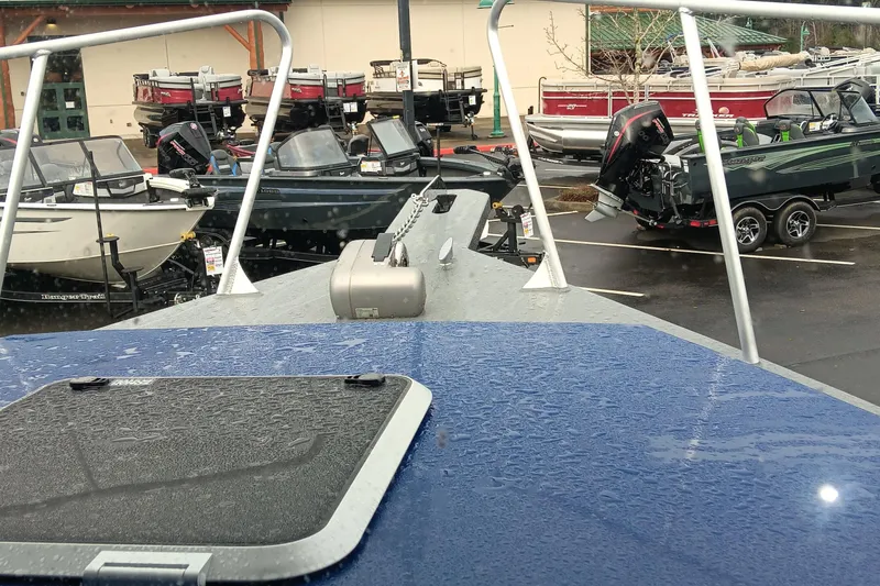 Slide: The Image of 2025 Spartan 2800 Olympia boat in a dealership lot, surrounded by various other boats. - 15