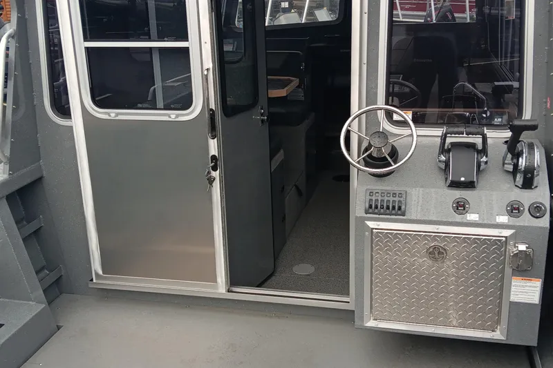 Slide: The Image of 2025 Spartan 2800 Olympia boat interior with steering wheel and control panel. - 8