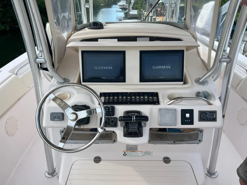 Slide: The Image of 2011 Grady-White Canyon 306 boat dashboard with Garmin navigation displays. - 10